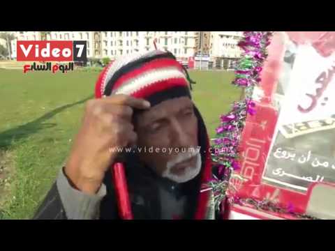 مسن يزين صورة السيسي ويرفعها بـالتحرير