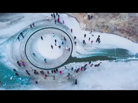 drone video shows rotating ice circle in frozen river