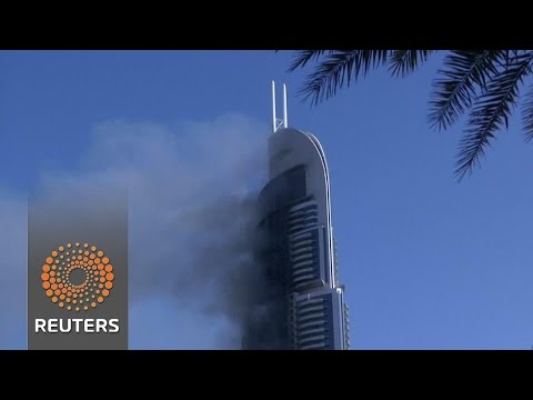 smoke billows from dubai skyscraper