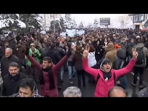 riot police fire water cannon on protesters