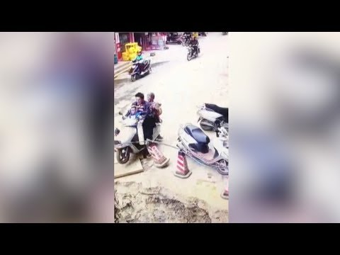 man drives motorcycle carrying family