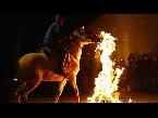 horses gallop through bonfires