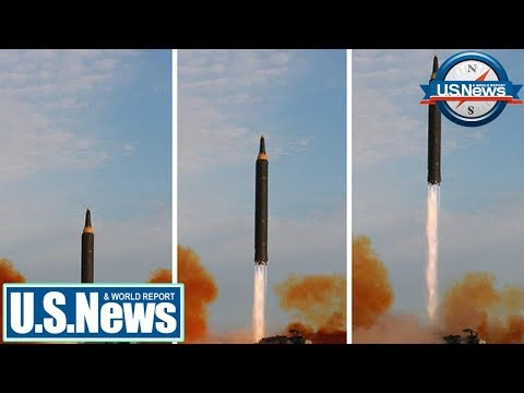 kim jongun laughs as north korea sends missile over japan